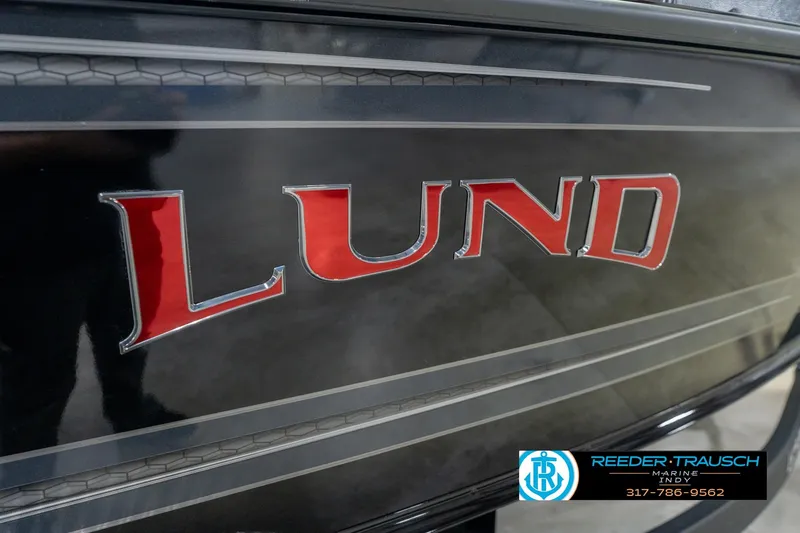 Slide: The Image of Close-up of 2026 Lund 1975 Pro-V Sport boat logo with dealership contact. - 57