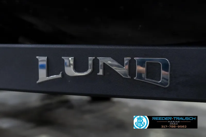 Slide: The Image of Chrome "Lund" logo on 2026 Lund 1975 Pro-V Sport boat, Reeder-Trausch Marine branding. - 62