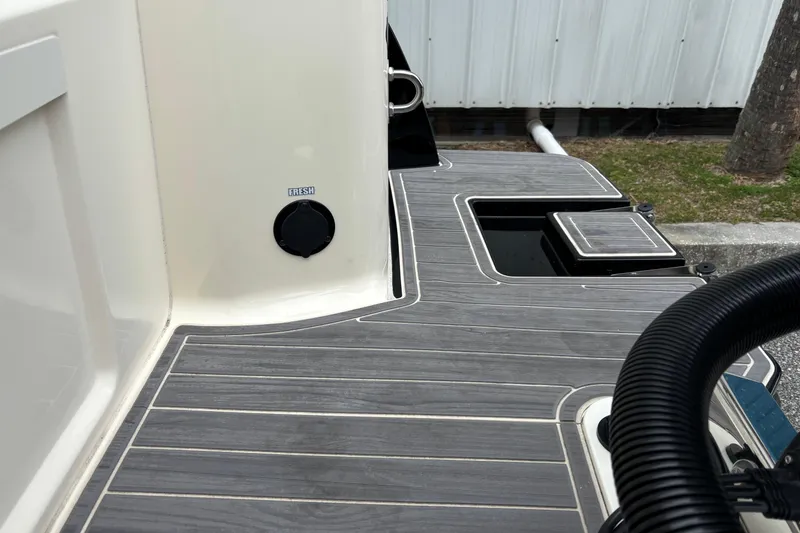 Slide: The Image of 2026 Scout 240 Dorado boat deck with sleek design and fresh water access. - 10