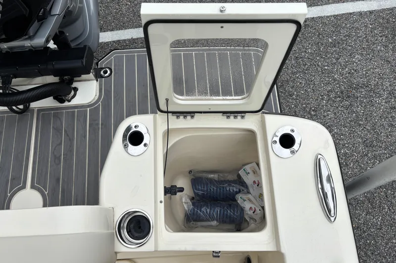 Slide: The Image of Open storage compartment on 2026 Scout 240 Dorado boat, showing interior contents. - 17