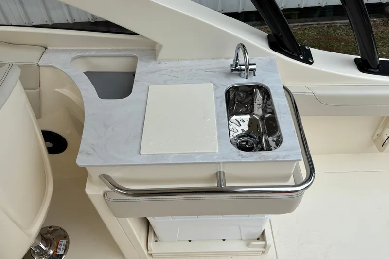 Slide: The Image of 2026 Scout 240 Dorado boat interior with sink and countertop. - 19