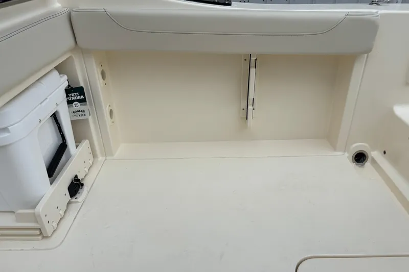 Slide: The Image of 2026 Scout 240 Dorado boat interior with Yeti cooler storage compartment. - 21