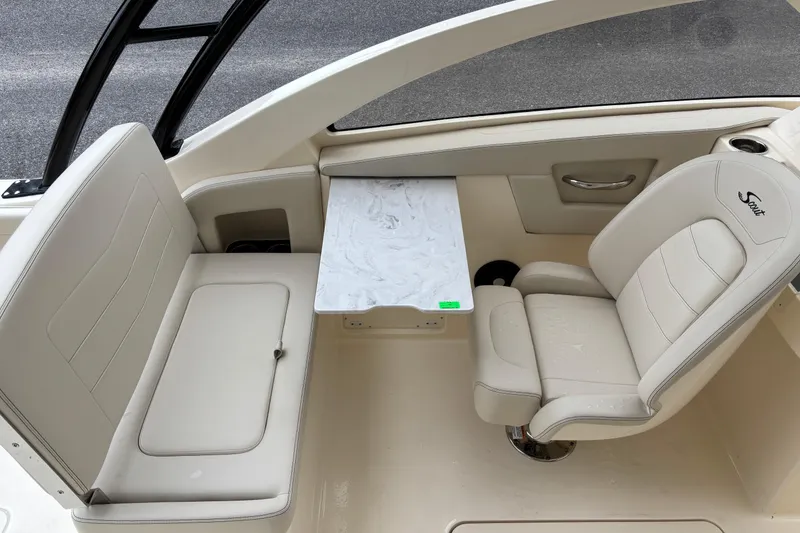Slide: The Image of Interior of 2026 Scout 240 Dorado boat with seating and table. - 24