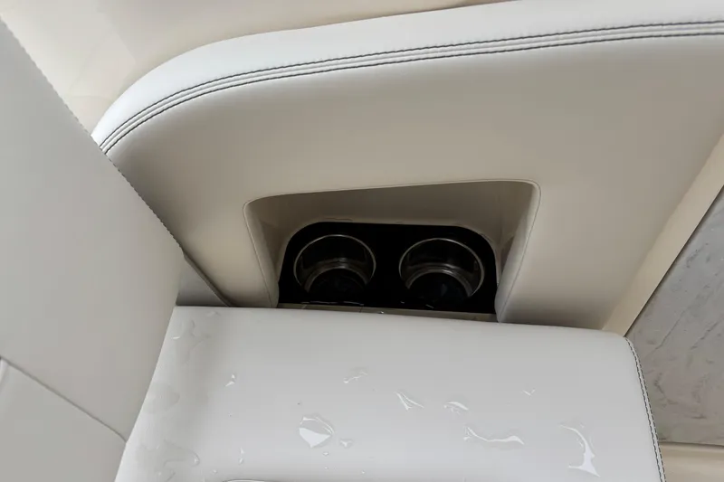 Slide: The Image of Cup holders in 2026 Scout 240 Dorado boat with white leather seating. - 26