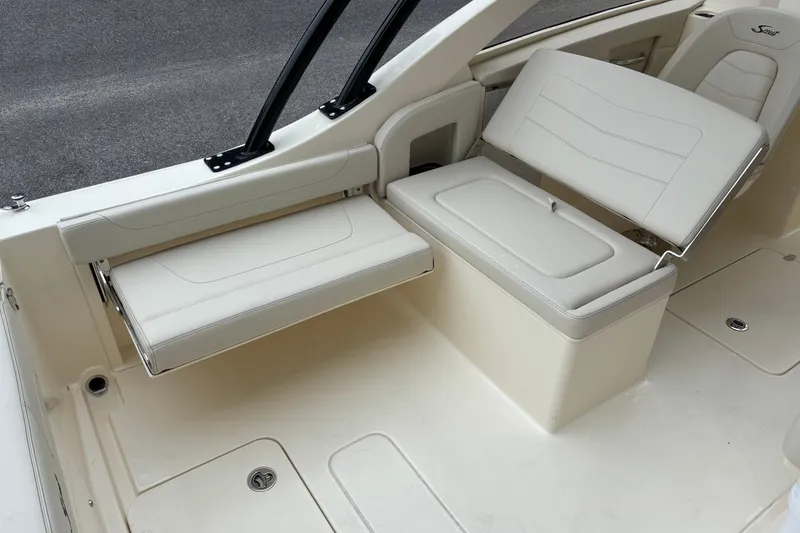 Slide: The Image of 2026 Scout 240 Dorado boat interior with white seating and sleek design. - 27