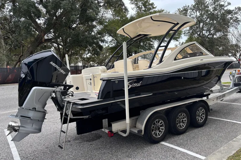 Slide: The Image of 2026 Scout 240 Dorado boat on trailer with Mercury outboard motor, parked outdoors. - 3
