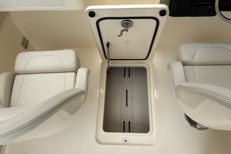 Slide: The Image of 2026 Scout 240 Dorado boat interior with open storage compartment and cushioned seats. - 31