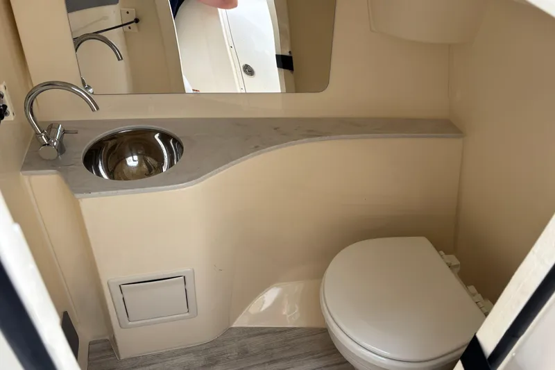 Slide: The Image of 2026 Scout 240 Dorado boat bathroom with sink, mirror, and toilet. - 34