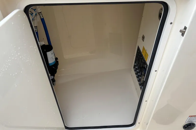 Slide: The Image of Storage compartment of 2026 Scout 240 Dorado boat, featuring internal components and wiring. - 35
