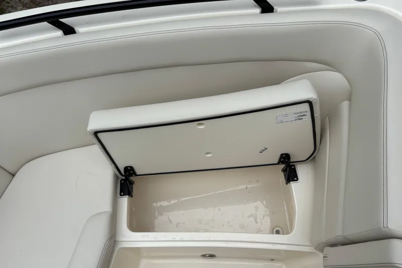 Slide: The Image of Open storage compartment on 2026 Scout 240 Dorado boat with white interior. - 41