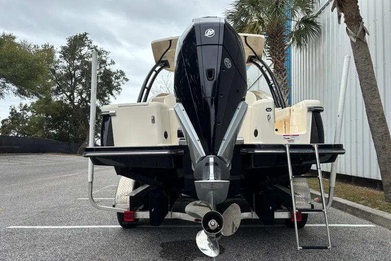 Slide: The Image of 2026 Scout 240 Dorado boat with powerful outboard motor, parked near palm trees. - 5