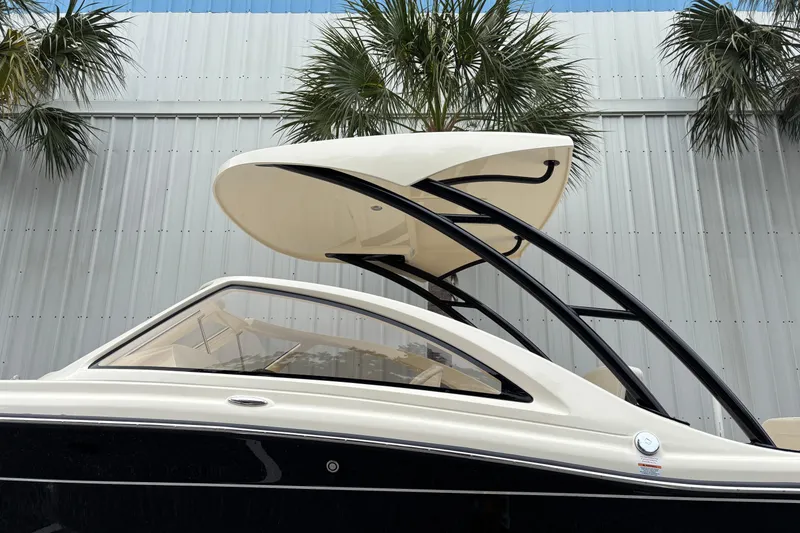Slide: The Image of 2026 Scout 240 Dorado boat with sleek design and modern canopy against a metal building backdrop. - 9