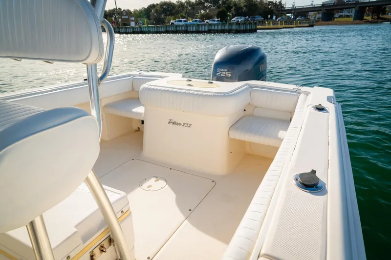 Slide: The Image of 2005 Sea Hunt Triton 232 boat interior with Yamaha 225 engine on calm water. - 15