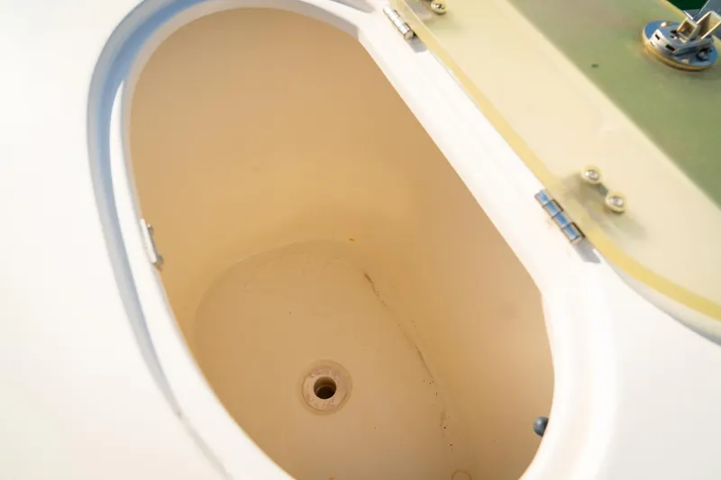 Slide: The Image of Livewell compartment on a 2005 Sea Hunt Triton 232 boat, open lid view. - 20
