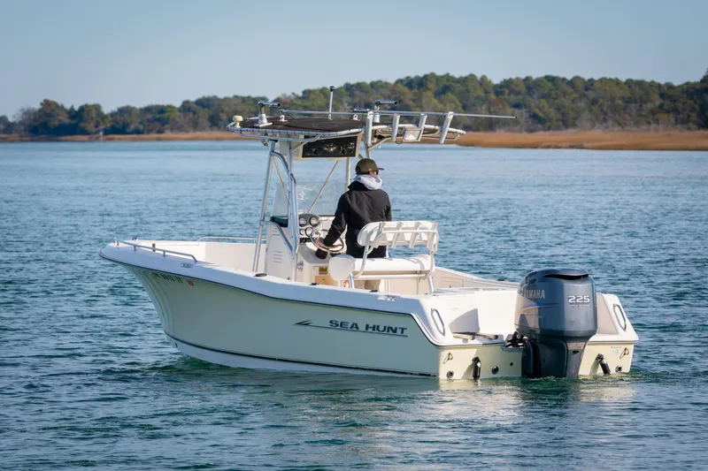 Slide: The Image of 2005 Sea Hunt Triton 232 boat on calm water with Yamaha outboard motor. - 7