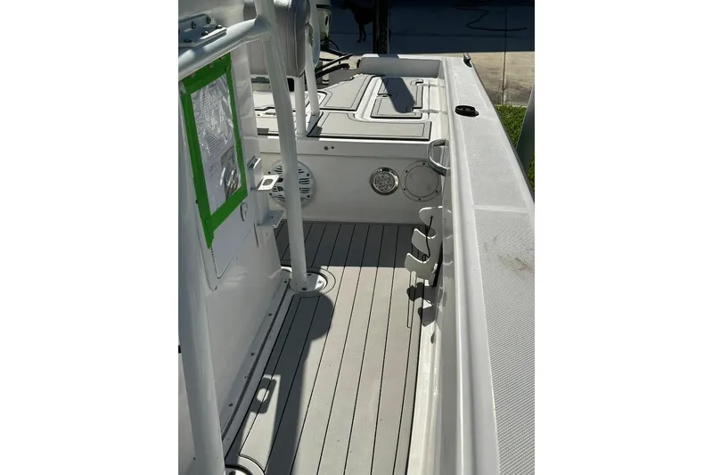 Slide: The Image of 1998 Sea Strike 18 CC boat interior with clean deck and rod holders. - 12