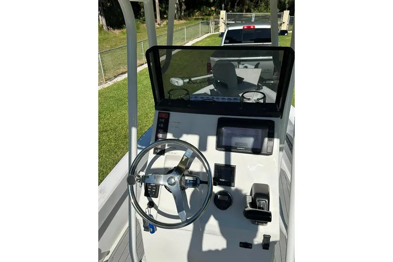 Slide: The Image of 1998 Sea Strike 18 CC boat console with steering wheel and navigation equipment. - 13