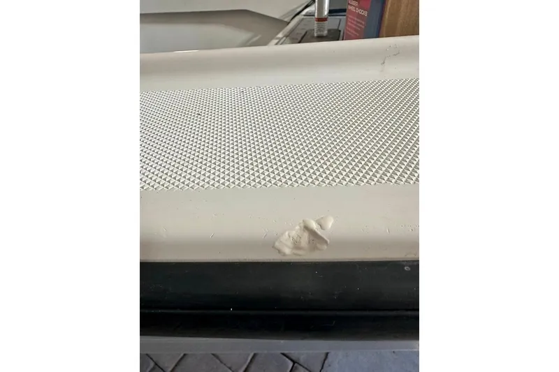 Slide: The Image of 1998 Sea Strike 18 CC boat with textured surface and minor damage. - 20