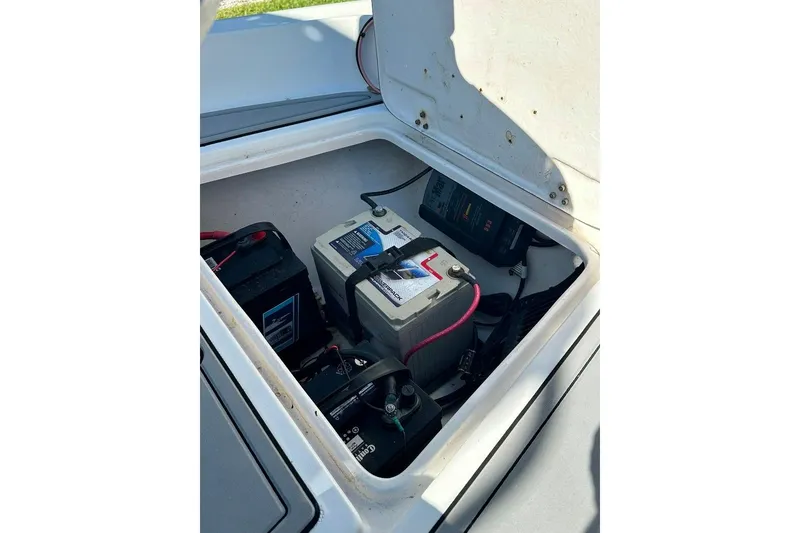 Slide: The Image of Battery compartment of a 1998 Sea Strike 18 CC boat, showing marine batteries and wiring. - 7