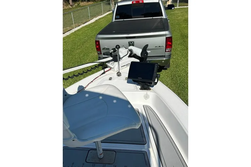 Slide: The Image of 1998 Sea Strike 18 CC boat with Garmin device, parked near a truck. - 8