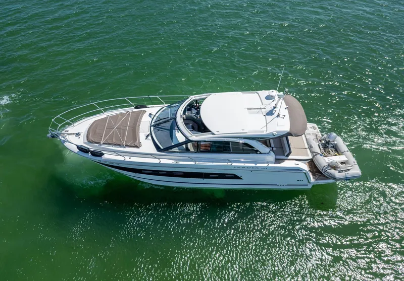 Slide: The Image of 2019 Jeanneau Leader 40 yacht cruising on clear green water. - 13