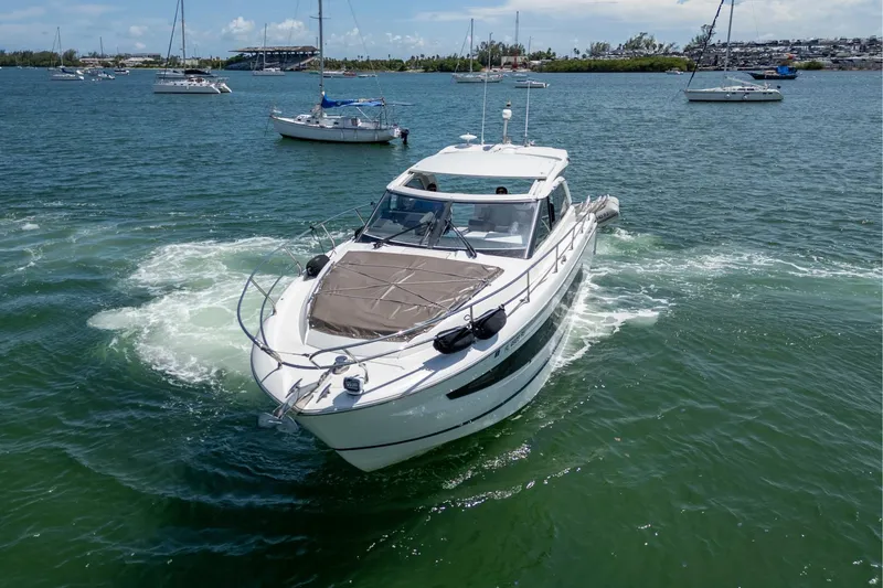 Slide: The Image of 2019 Jeanneau Leader 40 yacht cruising in a scenic bay with other boats. - 14