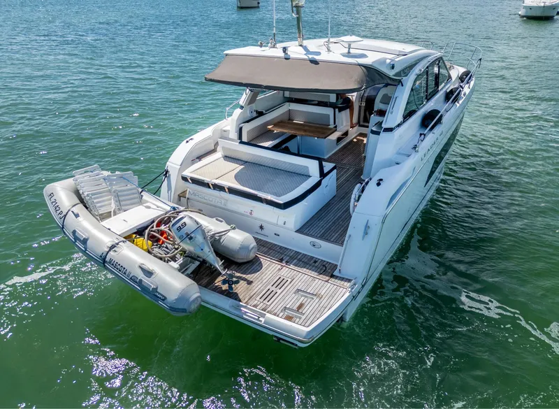 Slide: The Image of 2019 Jeanneau Leader 40 yacht with dinghy on calm water. - 25