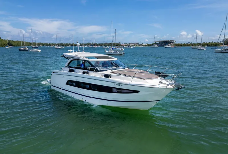 Slide: The Image of 2019 Jeanneau Leader 40 yacht cruising on a sunny day in a scenic harbor. - 27