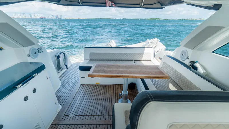 Slide: The Image of 2019 Jeanneau Leader 40 yacht interior with seating and table, cruising on open water. - 30
