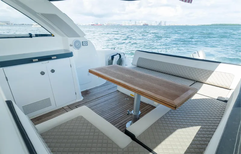 Slide: The Image of 2019 Jeanneau Leader 40 yacht interior with seating and table, overlooking the ocean. - 31