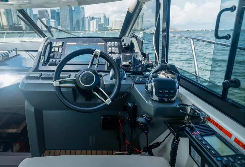 Slide: The Image of Helm of 2019 Jeanneau Leader 40 yacht with city skyline view. - 39