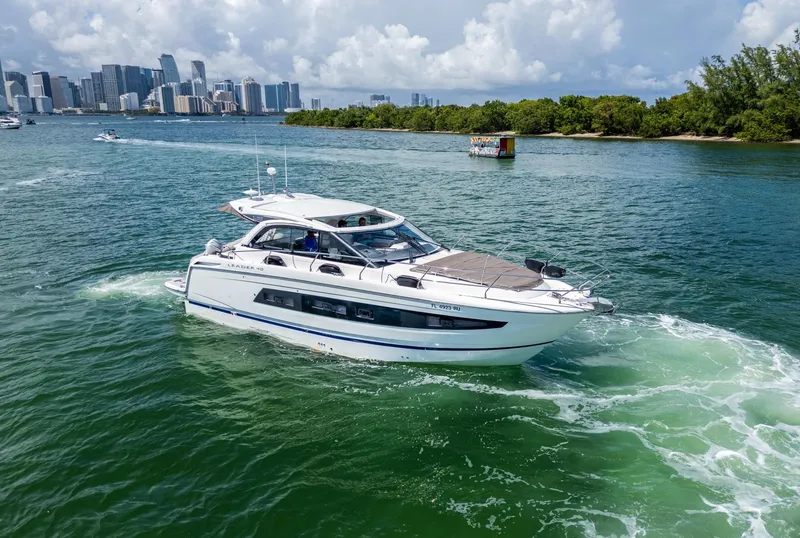 Slide: The Image of 2019 Jeanneau Leader 40 yacht cruising in scenic waters near a city skyline. - 6