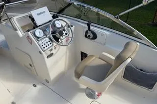 Slide: The Image of 2020 Scout 215 Dorado boat cockpit with steering wheel and control panel. - 10