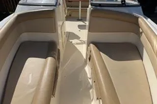 Slide: The Image of 2020 Scout 215 Dorado boat interior with beige seating and open deck layout. - 16