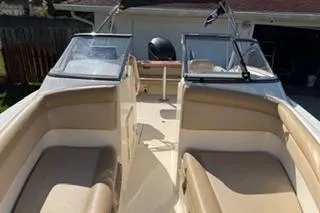 Slide: The Image of 2020 Scout 215 Dorado boat interior with beige seating and dual windshields. - 17