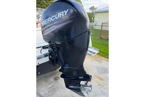 Slide: The Image of 2020 Scout 215 Dorado with Mercury outboard motor, parked outdoors. - 4