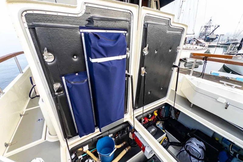Slide: The Image of Open storage compartment on 2020 Targa 32 boat, showcasing organized equipment and tools. - 14