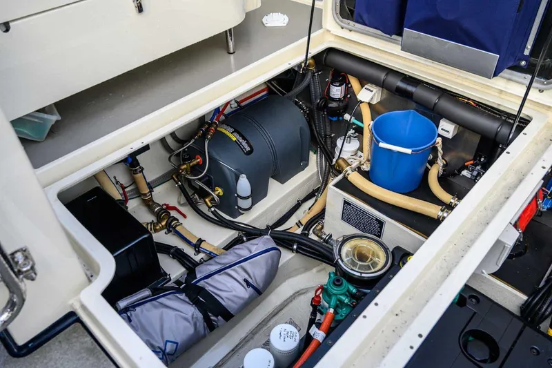 Slide: The Image of Engine compartment of 2020 Targa 32 boat, showcasing mechanical components and storage. - 18