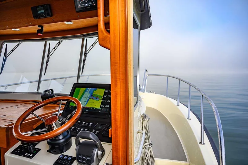 Slide: The Image of Pilot cabin of 2020 Targa 32 boat with steering wheel and navigation system. - 19