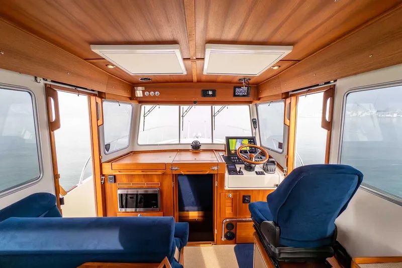Slide: The Image of Interior of 2020 Targa 32 boat with wooden finish and blue seating. - 20