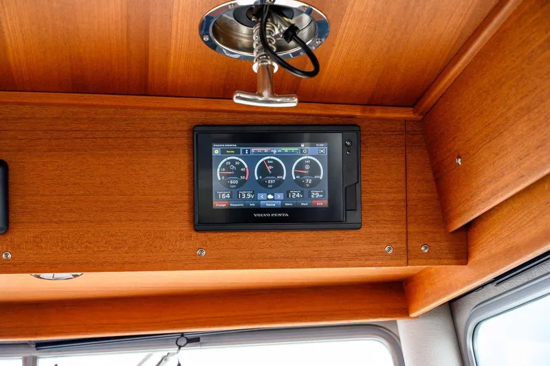 Slide: The Image of 2020 Targa 32 boat dashboard with Volvo Penta display, wooden interior. - 22