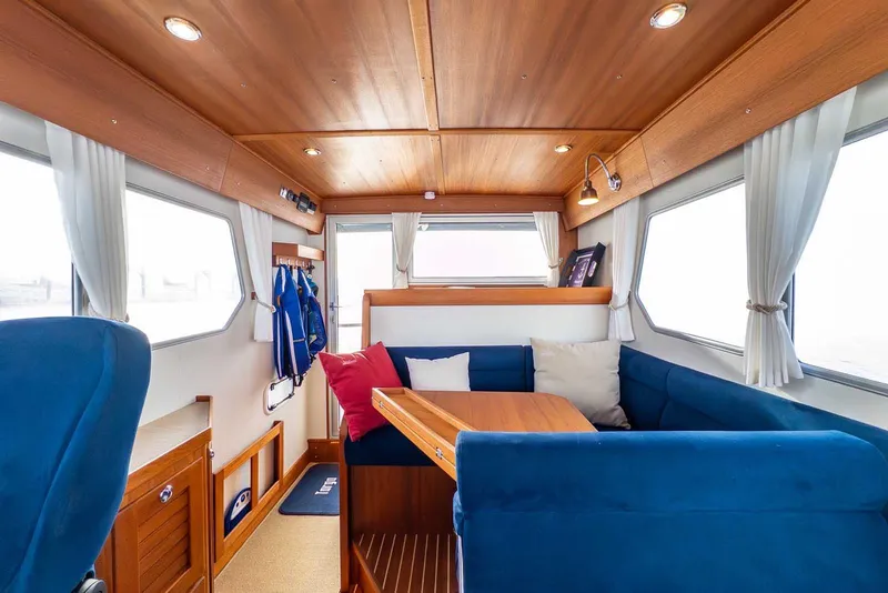 Slide: The Image of Interior of 2020 Targa 32 boat with blue seating and wooden accents. - 25