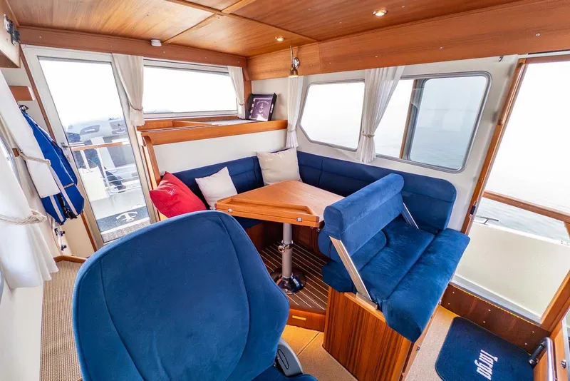 Slide: The Image of Cozy interior of 2020 Targa 32 boat with blue seating and wooden accents. - 26