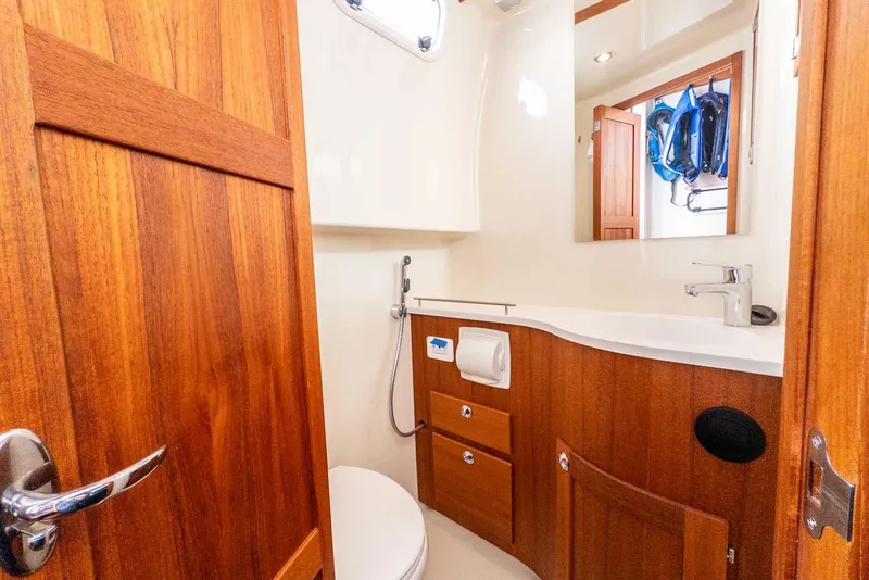 Slide: The Image of 2020 Targa 32 yacht bathroom with wooden cabinetry and modern fixtures. - 35