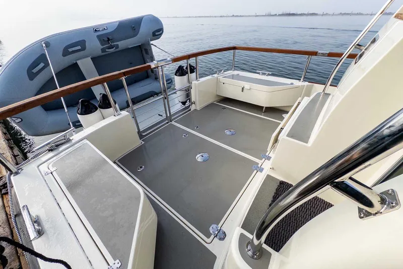 Slide: The Image of 2020 Targa 32 boat deck with inflatable dinghy, featuring sleek design and railing. - 4