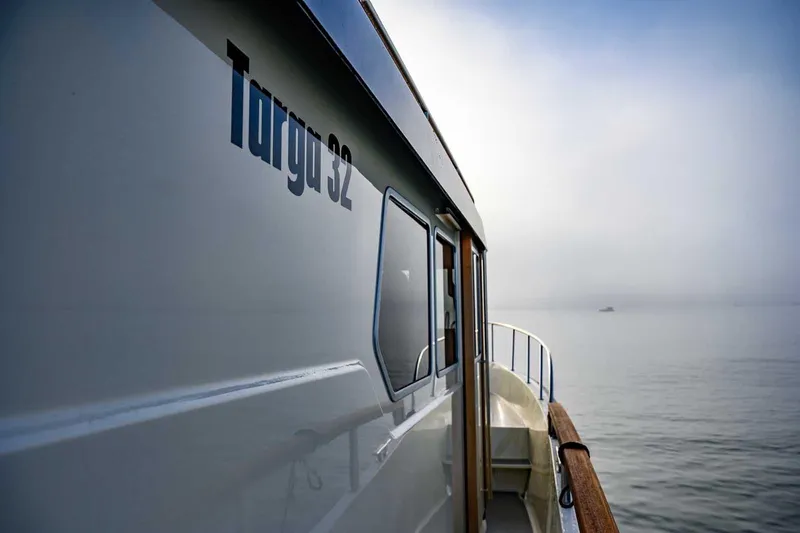 Slide: The Image of 2020 Targa 32 boat on calm water, side view with misty horizon. - 9