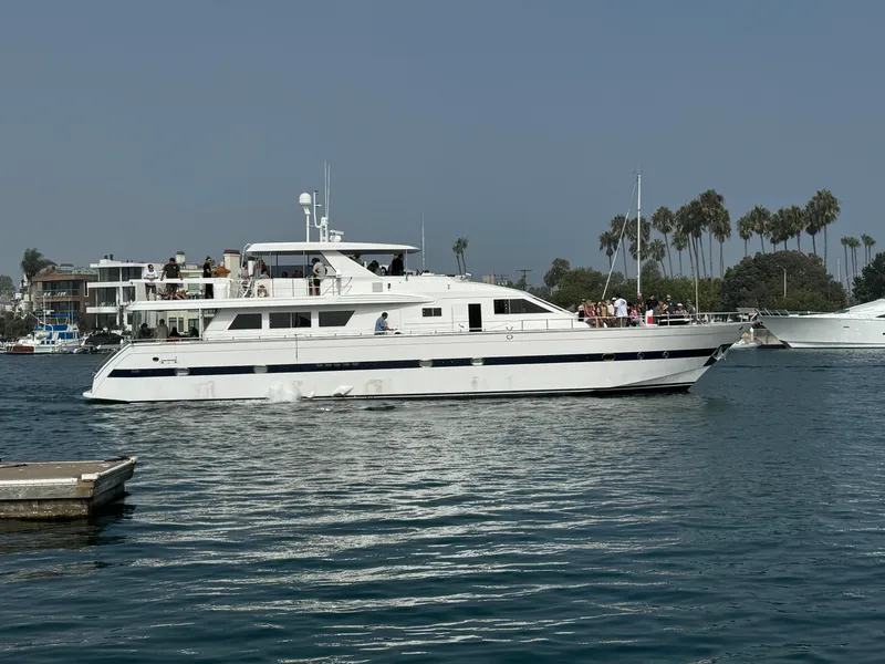 Slide: The Image of Versilcraft Challenger Motor Yacht 1990 cruising on a calm waterway with palm trees in the background. - 1