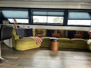 Slide: The Image of Luxurious 1990 Versilcraft Challenger yacht interior with green sofa and modern decor. - 19