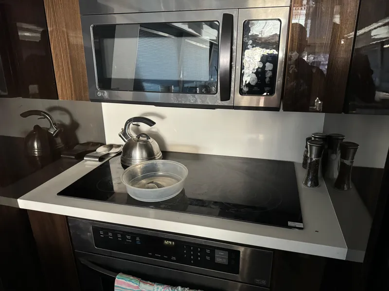 Slide: The Image of Modern kitchen in 1990 Versilcraft Challenger Motor Yacht with stove, microwave, and kettle. - 23