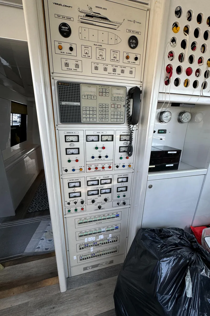 Slide: The Image of Control panel inside 1990 Versilcraft Challenger Motor Yacht, featuring various switches and gauges. - 28